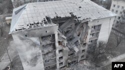 This handout picture from the Ukrainian Emergency Service on Feb. 21, 2024 shows a damaged building, where four residents were wounded, after a night attack to Pokrovsk district, Donetsk region. (Photo by Handout/Ukrainian Emergency Service via AFP) 