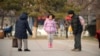 FILE — A girl plays with her family in Beijing, Dec. 7, 2012. During its 35 years, China's one-child policy fostered a culture of families doting on their only offspring. After the Chinese government ended the policy in 2016, it started encouraging couples to have more children.