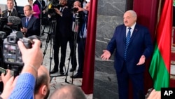 In this photo provided by the Belarusian Presidential Press Service, President Alexander Lukashenko talks to reporters after voting in Minsk, Belarus, Feb. 25, 2024.