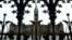 FILE - The Canadian Parliament building is framed through a gate on Parliament Hill in Ottawa, Ontario.