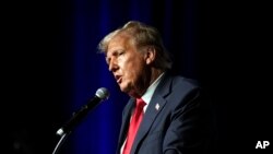 FILE - Republican presidential candidate Donald Trump speaks at Palm Beach County Convention Center in West Palm Beach, Florida, Oct. 11, 2023. Trump's lawyers are pushing for the revocation of a gag order in a federal case against him.