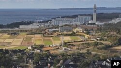 This aerial photo shows Shika nuclear power plant, rear, in Shika, on the western coast of the quake-struck Noto peninsula, Ishikawa prefecture, Japan, on Jan. 28, 2024.