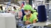 FILE - In this Oct. 24, 2017, photo, a worker sews a garment at Pro Sports factory in Nam Dinh province, Vietnam.