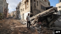 Residents inspect the damage at the Nur Shams refugee camp in the northern city of Tulkarm in the occupied West Bank, Sept. 24, 2023, following an Israeli raid.