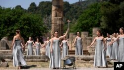 Performers take part in the final dress rehearsal of the flame lighting ceremony for the Paris Olympics, at the Ancient Olympia site, Greece, April 15, 2024. 