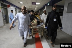 People transport a man, who was injured after a blast in Bajaur district of Khyber Pakhtunkhwa, at the Lady Reading Hospital in Peshawar, Pakistan, July 30, 2023.