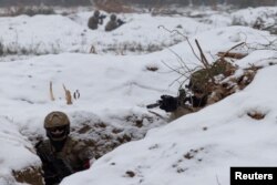 Ukrainian soldiers train in a trench during Combined Arms Training in Wedrzyn, Poland, on Dec. 7, 2023.