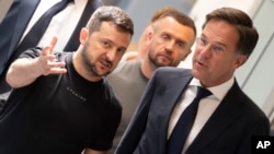Ukrainian President Volodymyr Zelenskyy, left, and Dutch caretaker Prime Minister Mark Rutte talk as they walk towards a press conference in Eindhoven, Netherlands, Aug. 20, 2023.
