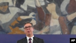 FILE - Serbian President Aleksandar Vucic speaks during a public address in Belgrade, Serbia, May 5, 2023. Opposition parties have said that Vucic's populist government has fueled intolerance and hate speech, while taking hold of all institutions, thus stoking divisions. Vucic has denied this.
