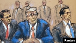 FILE - Former U.S. President Donald Trump sits between lawyers Todd Blanche and John Lauro in a courtroom sketch made in Washington, Aug. 3, 2023. Trump's lawyers have asked that his trial on charges he illegally tried to overturn the 2020 presidential election be held in 2026.