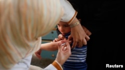 FILE - A Palestinian boy receives polio vaccine at a hospital in Khan Younis in the southern Gaza Strip, Feb. 23, 2014. 