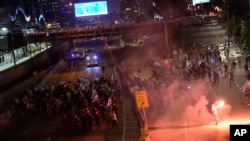 Demonstrators block a highway during a protest against plans by Prime Minister Benjamin Netanyahu's government to overhaul the judicial system in Tel Aviv, Israel, March 25, 2023.