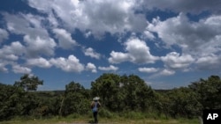 FILE - A Jaintia tribal man stands by a sprawling sacred forest in Jaintia Hills, a sparsely populated mountainous region of Meghalaya, a state in northeastern India, Sept. 6, 2023.