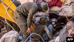Rescue workers search for survivors in a collapsed house in Moulay Brahim, Al Haouz province, Morocco, after an earthquake, Sept. 9, 2023.
