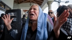 A supporter of slain presidential candidate Fernando Villavicencio mourns as his coffin arrives at Camposanto Monteolivo cemetery for burial in Quito, Ecuador, Aug. 11, 2023.