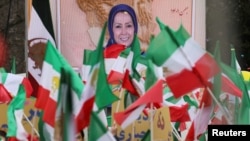 FILE - Iranian community members and supporters of the National Council of Resistance of Iran, or NCRI, take part in a protest in solidarity with Iranian people, in Paris, France, Feb. 12, 2023. France has banned an upcoming NCRI rally over safety concerns.