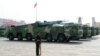 FILE - Military vehicles carrying hypersonic missiles drive past Tiananmen Square during the military parade marking the 70th founding anniversary of People's Republic of China, on its National Day in Beijing, Oct. 1, 2019.