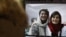 FILE - A woman looks at a computer screen with a photo of Iranian journalists Niloufar Hamedi and Elaheh Mohammadi, in Nicosia, Cyprus, Nov. 2, 2022. 