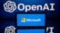FILE - This illustration photo taken Jan. 23, 2023, shows screens displaying the logos of Microsoft and OpenAI.