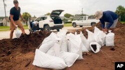 St. Johns County residents fill sand bags in Crescent Beach, Florida, as they prepare for the arrival of Hurricane Idalia, Aug. 29, 2023.