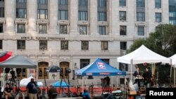 Los medios se estacionan fuera del Palacio de Justicia Lewis R. Slaton después de que un gran jurado presentara acusaciones contra el expresidente Donald Trump, en Atlanta, Georgia, el 15 de agosto de 2023.