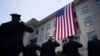 First responders salute as an American flag is unfurled at the Pentagon at sunrise to commemorate the 2001 terrorist attack on the Pentagon, during an observance ceremony Sept. 11, 2023. 