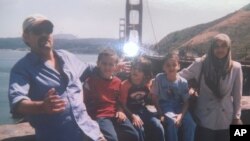 This undated image provided by Fadi Sckak shows a family photo of Abedalla Sckak, left, with his wife Zahra Sckak, far right, and children. Abedalla Sckak, 56, died after being shot in the fighting in Gaza last month.