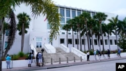 FILE - News media wait outside of the U.S. Courthouse in Fort Pierce, Florida, on July 18, 2023. U.S. District Judge Aileen Cannon has indicated that the classified-documents case against former President Donald Trump will be held there