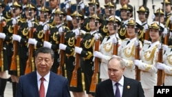 Russia's President Vladimir Putin and China's President Xi Jinping attend an official welcoming ceremony in front of the Great Hall of the People in Tiananmen Square in Beijing on May 16, 2024. ( Sergei Bobylyov/Sputnik/viaAFP)