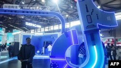 FILE - A man walks by a TikTok booth at the Appliance & Electronics World Expo in Shanghai, China, March 14, 2024. TikTok and parent company ByteDance laid out their arguments this week why a new law that could see the service effectively banned in the U.S. should be struck down.