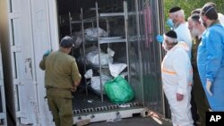 Bodies of Israelis killed in an unprecedented Hamas attack are stored for identification, at a military base in Ramla, Israel, Oct. 13, 2023.