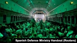 Spanish diplomatic personnel and citizens wait to disembark a military plane in Djibouti, after they were evacuated from Sudan, April 24, 2023.