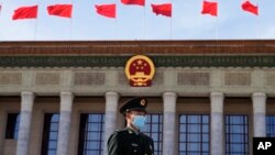 File - A Chinese soldier stands guard outside the Great Hall of the People after the opening ceremony of The Third Belt and Road Forum in Beijing, Oct. 18, 2023. 