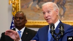 U.S. President Joe Biden delivers remarks on recovery efforts for the Maui wildfires and the response to Hurricane Idalia in the Roosevelt Room of the White House in Washington, Aug. 30, 2023. Secretary of Defense Lloyd Austin, left, stands behind him.