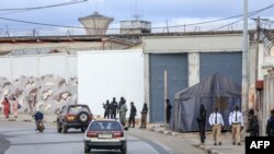 FILE - A general view of men in uniform outside the central prison in Libreville, Gabon, Sept. 11, 2023. Police in Gabon say a crime wave has hit the capital Libreville several days after the country’s transitional president pardoned and set free over 500 prisoners.