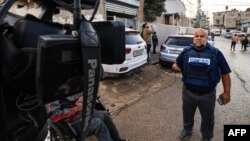 FILE - Al Jazeera's Gaza bureau chief Wael al-Dahdouh works in Rafah in the southern Gaza Strip, Dec. 12, 2023, amid continuing battles between Israel and the Palestinian Hamas militant group.