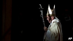 FILE - Pope Francis holds the pastoral staff as he leaves after celebrating a Mass in St. Peter's Basilica, at the Vatican, to mark Epiphany, Jan. 6, 2014. 