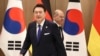 German Chancellor Olaf Scholz, rear, and South Korea's President Yoon Suk Yeol arrive for their meeting at the Presidential Office in Seoul, South Korea, May 21, 2023. Scholz arrived in Seoul after attending the G7 summit in Hiroshima, Japan.