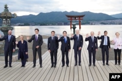 Left to right: European Council President Charles Michel, Italy's Primer Minister Giorgia Meloni, Canada's Prime Minister Justin Trudeau, France's President Emmanuel Macron, Japan's Prime Minister Fumio Kishida, U.S. President Joe Biden, German Chancellor Olaf Scholz, Britain's Prime Minister Rishi Sunak and European Commission President Ursula von der Leyen pose for a photo during a visit to the Itsukushima Shrine in Miyajima Island as part of the G7 Leaders' Summit, May 19, 2023.