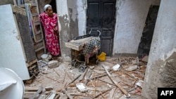 A woman inspects the damage following a 6.8 magnitude quake in Marrakech, Morocco, Sept. 9, 2023.