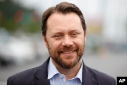 Jason Carter, grandson of former President Jimmy Carter, left, speaks with media during a ceremony honoring President Carter, in Norcross, Georgia, May 23, 2023.