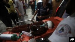 A young Palestinian wounded in the Israeli bombardment of the Gaza Strip is brought to the Kuwaiti Hospital in Rafah refugee camp, southern Gaza Strip, April 20, 2024.