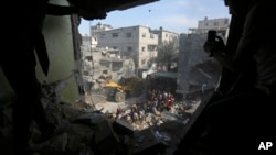 Palestinians look for survivors after an Israeli strike on the Gaza Strip in Rafah, Oct. 30, 2023. 