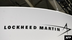 FILE - The Lockheed Martin logo is seen during the annual International Astronautical Congress at the Walter E. Washington Convention Center in Washington, Oct. 22, 2019. 