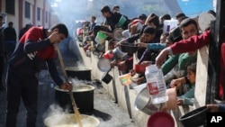Palestinians line up for a free meal in Rafah, Gaza Strip, Dec. 20, 2023.