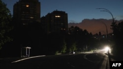 A car goes down a dark street during a partial electricity blackout in Kyiv, Ukraine, on June 5, 2024, following Russian strikes on Ukrainian energy infrastructure.