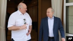 FILE - Russian President Vladimir Putin, right, and Belarusian President Alexander Lukashenko speak during their meeting at the Bocharov Ruchei residence in the resort city of Sochi, Russia, Friday, June 9, 2023. 