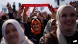Justice and Development Party (AKP) supporters listen to party leader Recep Tayyip Erdogan, Turkey's president, during a campaign rally ahead of nationwide municipality elections, in Istanbul, March 24, 2024.