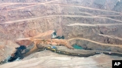 In this aerial photo released by China's Xinhua News Agency, rescuers work at the site of a collapsed open pit coal mine in Alxa League in northern China's Inner Mongolia Autonomous Region, Feb. 23, 2023.