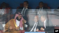 FILE - Saudi Arabia Crown Prince Mohammed bin Salman, left, FIFA President Gianni Infantino, center, and Russian President Vladimir Putin attend the 2018 soccer World Cup in Moscow, Russia, June 14, 2018. Saudi Arabia is expected to host the men's 2034 World Cup.